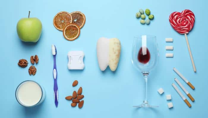 A dual-sided tooth, half clean and half decayed, surrounded by good and bad foods for dental health on a blue background.